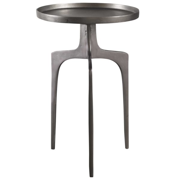 Providing an organic global feel, this cast aluminum accent table features a shapely curved base and round top, finished in a textured nickel.