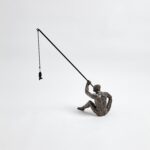 This fisherman is cast iron with a bronze finish. He sits comfortably on a shelf or table.DimensionsOverall 14.25"L x 6"W x 17.5"H (8.1 lbs)BronzeDust with dry cloth