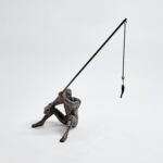 This fisherman is cast iron with a bronze finish. He sits comfortably on a shelf or table.DimensionsOverall 14.25"L x 6"W x 17.5"H (8.1 lbs)BronzeDust with dry cloth